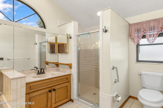 523 Hidden Hollow Dr, Merritt Island, FL 32952 - bathroom with a textured ceiling, toilet, vanity, a stall shower, and tile patterned flooring