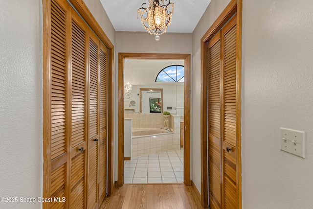 523 Hidden Hollow Dr, Merritt Island, FL 32952 - hall with light wood-style flooring and a notable chandelier