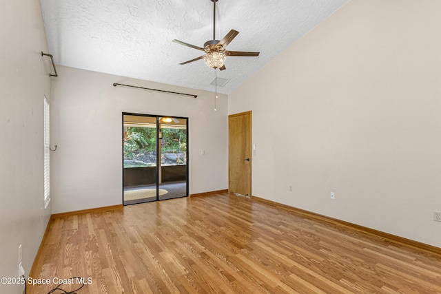 523 Hidden Hollow Dr, Merritt Island, FL 32952 - unfurnished room with high vaulted ceiling, a textured ceiling, baseboards, a ceiling fan, and light wood-type flooring
