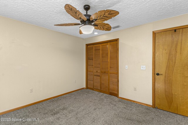 523 Hidden Hollow Dr, Merritt Island, FL 32952 - unfurnished bedroom with carpet flooring, a textured ceiling, baseboards, and visible vents