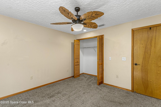 523 Hidden Hollow Dr, Merritt Island, FL 32952 - unfurnished bedroom featuring carpet floors, baseboards, ceiling fan, and a textured ceiling