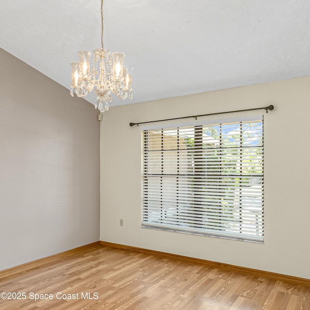 523 Hidden Hollow Dr, Merritt Island, FL 32952 - spare room featuring baseboards, an inviting chandelier, and light wood finished floors