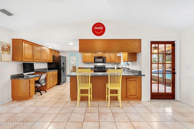 kitchen featuring light tile patterned floors, built in desk, black appliances, visible vents, and a peninsula