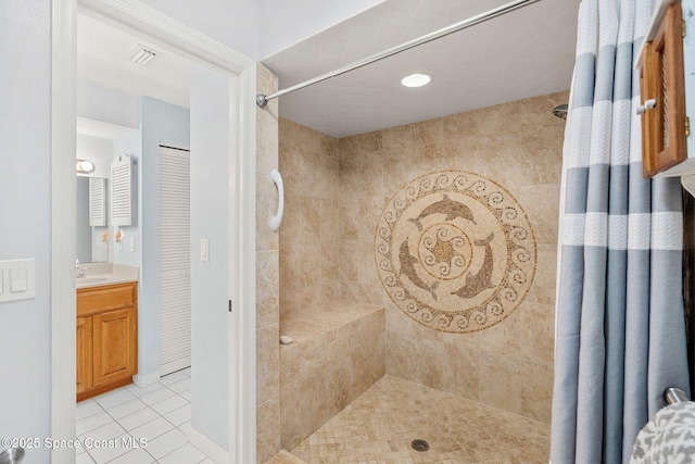 full bath featuring visible vents, vanity, tile patterned flooring, and tiled shower