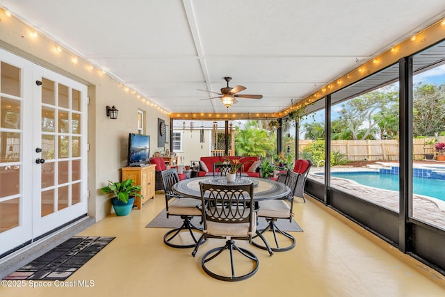 sunroom with outdoor dining space, ceiling fan, and french doors