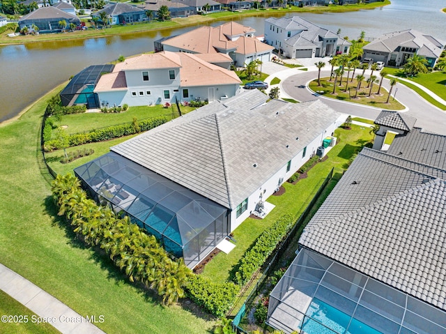 birds eye view of property with a water view and a residential view