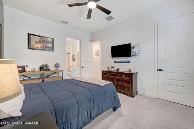 bedroom featuring light colored carpet, visible vents, baseboards, and ensuite bath