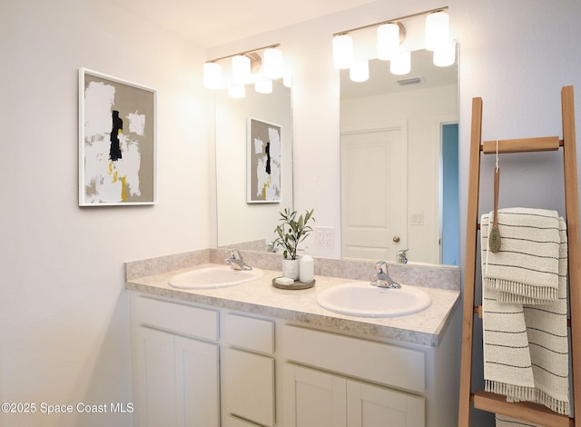 full bathroom with double vanity, visible vents, and a sink