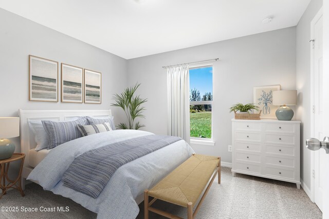 carpeted bedroom featuring baseboards