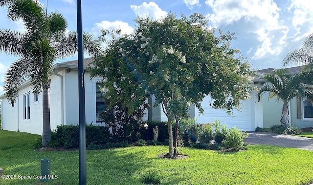 2364 Trift Bridge Cir, Melbourne, FL 32940 - view of front facade with stucco siding, an attached garage, driveway, and a front yard