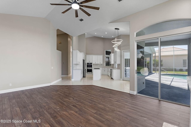 706 Palmer Way, Melbourne, FL 32940 - unfurnished living room with high vaulted ceiling, a ceiling fan, light wood-style floors, and baseboards