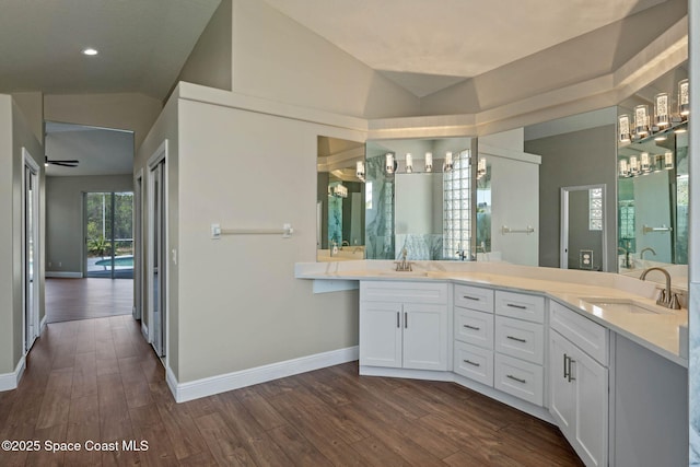 706 Palmer Way, Melbourne, FL 32940 - full bath with lofted ceiling, wood finished floors, baseboards, double vanity, and recessed lighting