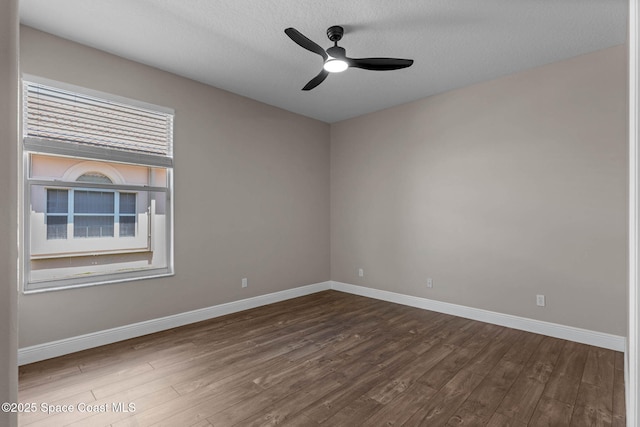706 Palmer Way, Melbourne, FL 32940 - unfurnished room with dark wood-type flooring, baseboards, and a textured ceiling