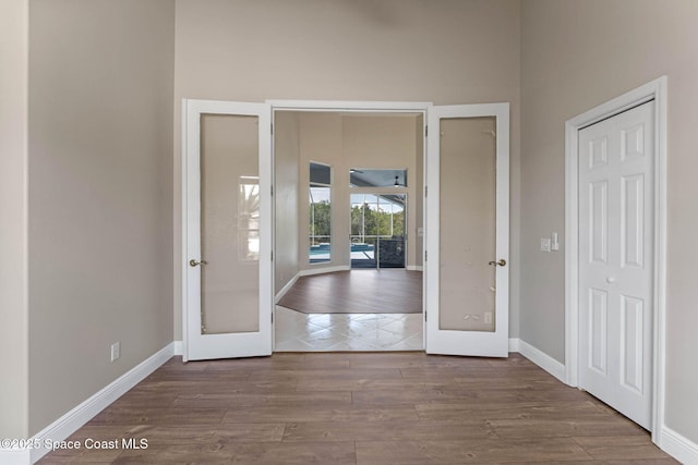 706 Palmer Way, Melbourne, FL 32940 - entrance foyer with french doors, wood finished floors, and baseboards
