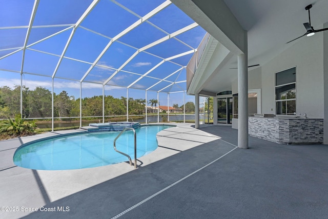 706 Palmer Way, Melbourne, FL 32940 - view of pool featuring a patio area, glass enclosure, an outdoor kitchen, and a pool with connected hot tub