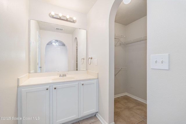 2728 Maderia Cir, Melbourne, FL 32935 - bathroom featuring a spacious closet, tile patterned flooring, vanity, and visible vents