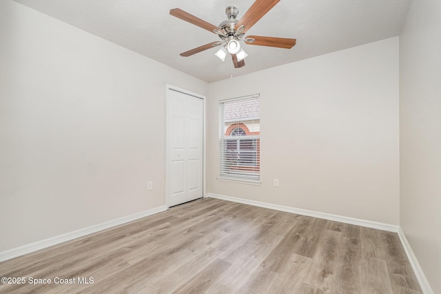 2728 Maderia Cir, Melbourne, FL 32935 - unfurnished room featuring baseboards, a ceiling fan, and light wood-style floors