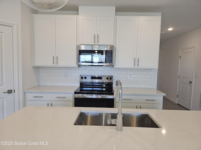 kitchen with white cabinets, a sink, and appliances with stainless steel finishes