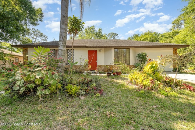1666 Yamada St SE, Palm Bay, FL 32909 - ranch-style home with a garage, driveway, and stucco siding