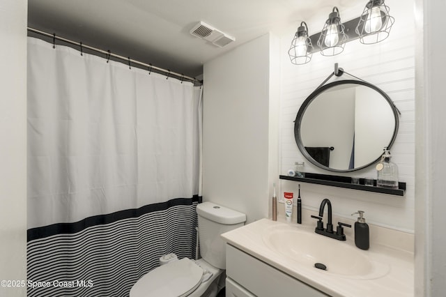 bathroom featuring toilet, vanity, a shower with shower curtain, and visible vents