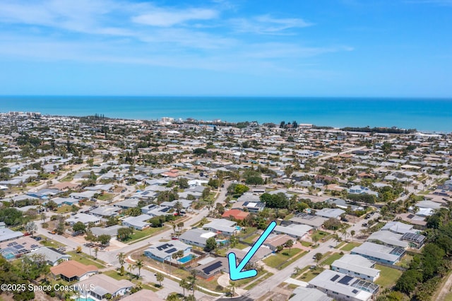 drone / aerial view featuring a water view and a residential view