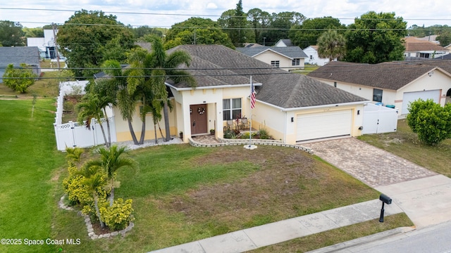 2748 Emerson Dr SE, Palm Bay, FL 32909 - view of front of property with decorative driveway, an attached garage, stucco siding, a shingled roof, and a gate