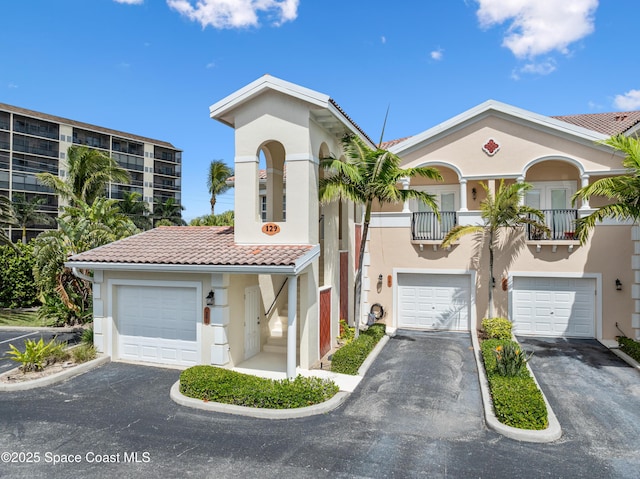 129 Lancha Cir Unit 201, Indian Harbour Beach, FL 32937 - mediterranean / spanish house featuring a tile roof, driveway, and stucco siding