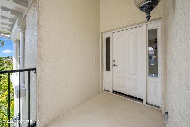 129 Lancha Cir Unit 201, Indian Harbour Beach, FL 32937 - property entrance with stucco siding and a balcony