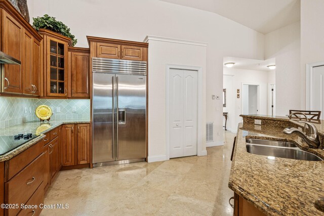 129 Lancha Cir Unit 201, Indian Harbour Beach, FL 32937 - kitchen featuring a sink, stone countertops, built in refrigerator, black electric cooktop, and visible vents