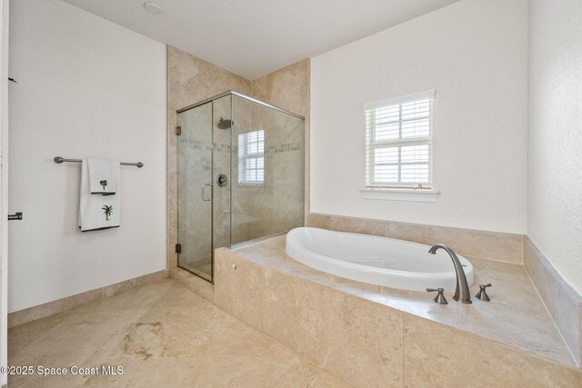 129 Lancha Cir Unit 201, Indian Harbour Beach, FL 32937 - full bathroom with a stall shower, baseboards, and a garden tub