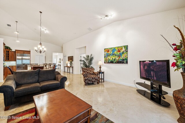 129 Lancha Cir Unit 201, Indian Harbour Beach, FL 32937 - living room featuring baseboards, high vaulted ceiling, visible vents, and a chandelier