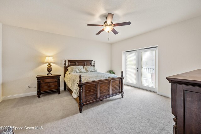 129 Lancha Cir Unit 201, Indian Harbour Beach, FL 32937 - bedroom with french doors, baseboards, access to outside, a ceiling fan, and light carpet