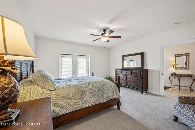 129 Lancha Cir Unit 201, Indian Harbour Beach, FL 32937 - bedroom with light colored carpet, french doors, baseboards, visible vents, and a ceiling fan