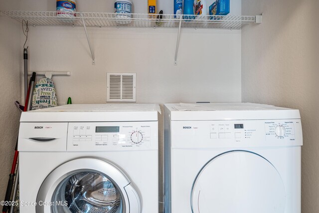 129 Lancha Cir Unit 201, Indian Harbour Beach, FL 32937 - washroom with visible vents and washer and clothes dryer