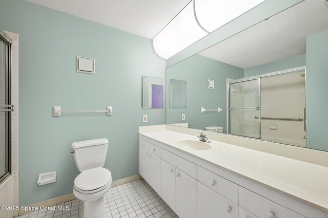 787 Greenwood Manor Cir Unit 14, West Melbourne, FL 32904 - bathroom featuring vanity, toilet, a shower with door, and tile patterned floors