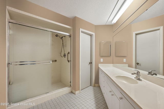 787 Greenwood Manor Cir Unit 14, West Melbourne, FL 32904 - bathroom featuring tile patterned floors, vanity, a textured ceiling, and a stall shower