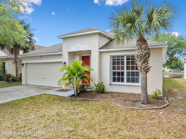 3666 Mount Carmel Ln, Melbourne, FL 32901 - view of front of property with an attached garage, stucco siding, concrete driveway, roof with shingles, and a front lawn