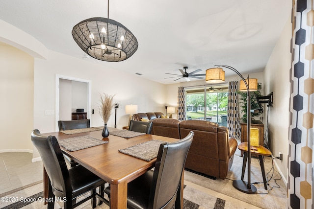 3666 Mount Carmel Ln, Melbourne, FL 32901 - dining space with arched walkways, ceiling fan, and light tile patterned floors