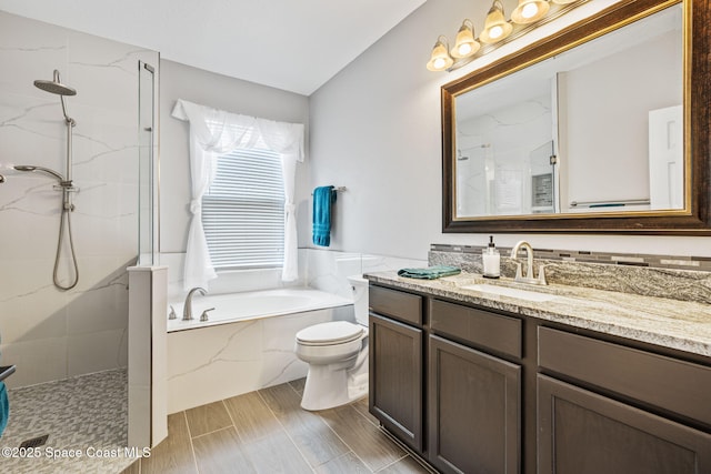 3666 Mount Carmel Ln, Melbourne, FL 32901 - bathroom featuring vanity, a marble finish shower, a bath, and toilet
