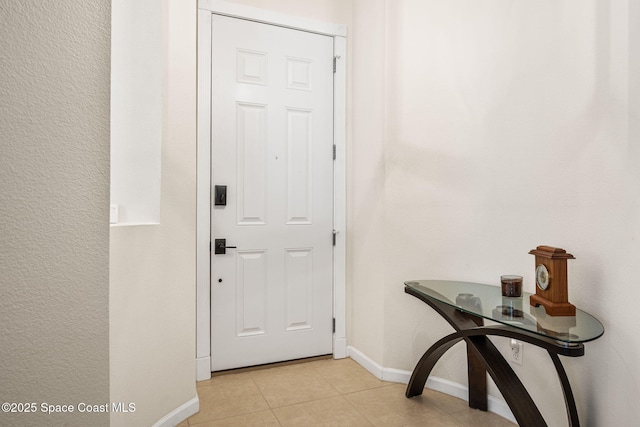 3666 Mount Carmel Ln, Melbourne, FL 32901 - entryway with baseboards and light tile patterned flooring