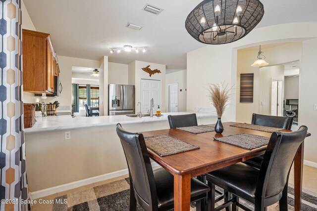 3666 Mount Carmel Ln, Melbourne, FL 32901 - dining area with ceiling fan and a chandelier