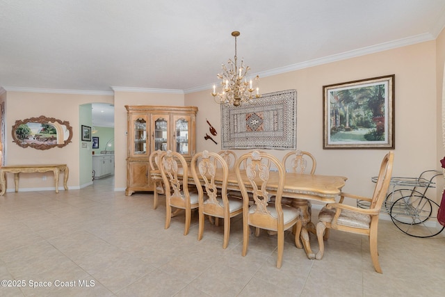 2298 Mantilla Ave SE, Palm Bay, FL 32909 - dining space with arched walkways, ornamental molding, baseboards, and an inviting chandelier