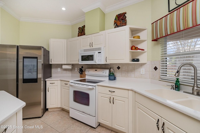 2298 Mantilla Ave SE, Palm Bay, FL 32909 - kitchen with a sink, tasteful backsplash, light tile patterned floors, white appliances, and ornamental molding