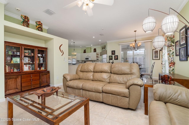 2298 Mantilla Ave SE, Palm Bay, FL 32909 - living room with crown molding, light tile patterned floors, ceiling fan with notable chandelier, baseboards, and visible vents