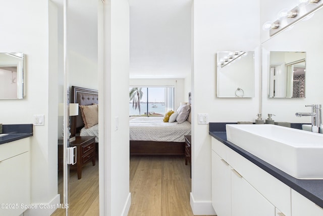 6365 Bahia Del Mar Blvd S Unit 210, Saint Petersburg, FL 33710 - ensuite bathroom with vanity, ensuite bathroom, a towering ceiling, and wood finished floors