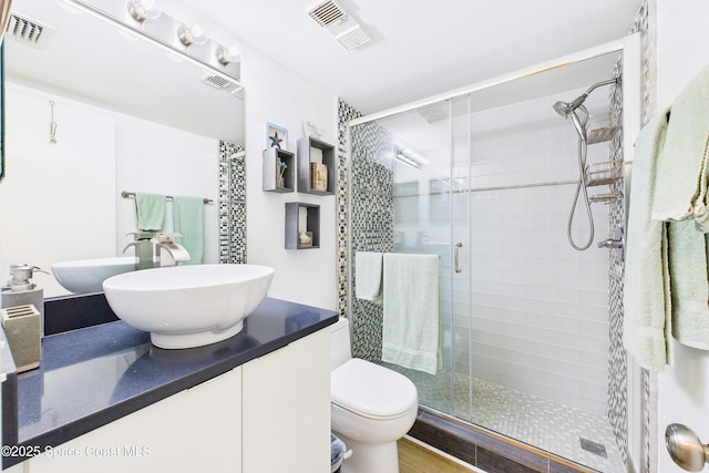 6365 Bahia Del Mar Blvd S Unit 210, Saint Petersburg, FL 33710 - full bathroom with a stall shower, visible vents, toilet, and vanity