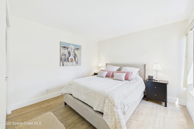 6365 Bahia Del Mar Blvd S Unit 210, Saint Petersburg, FL 33710 - bedroom featuring baseboards and light wood-style flooring