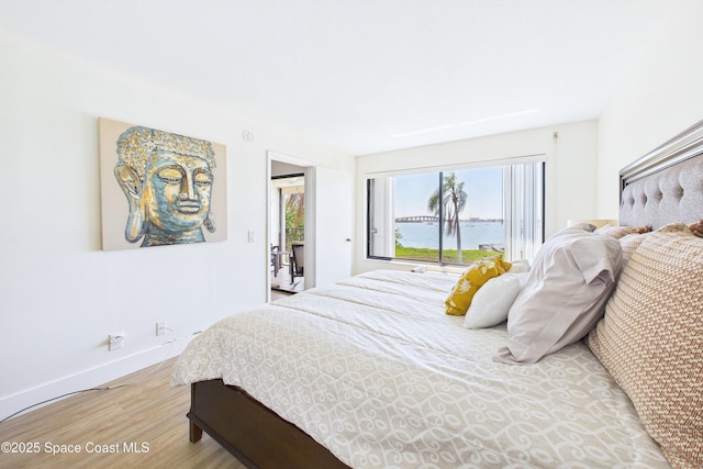 6365 Bahia Del Mar Blvd S Unit 210, Saint Petersburg, FL 33710 - bedroom with baseboards, a water view, and light wood finished floors