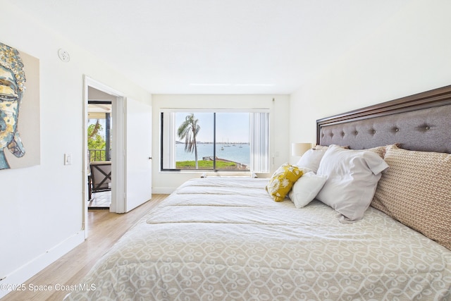 6365 Bahia Del Mar Blvd S Unit 210, Saint Petersburg, FL 33710 - bedroom with baseboards, multiple windows, and wood finished floors