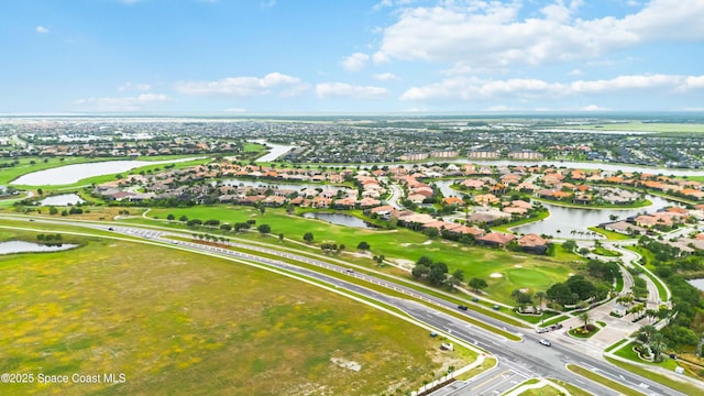 bird's eye view featuring a water view, view of golf course, and a residential view